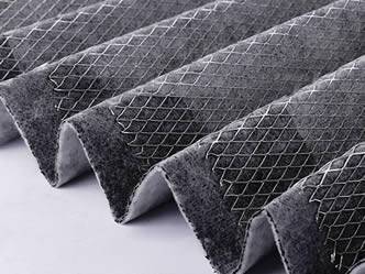 A piece of pleated carbon filter with the expanded metal mesh support layer.